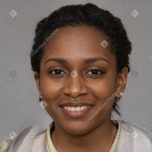 Joyful black young-adult female with short  black hair and brown eyes