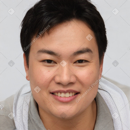 Joyful asian young-adult male with short  brown hair and brown eyes