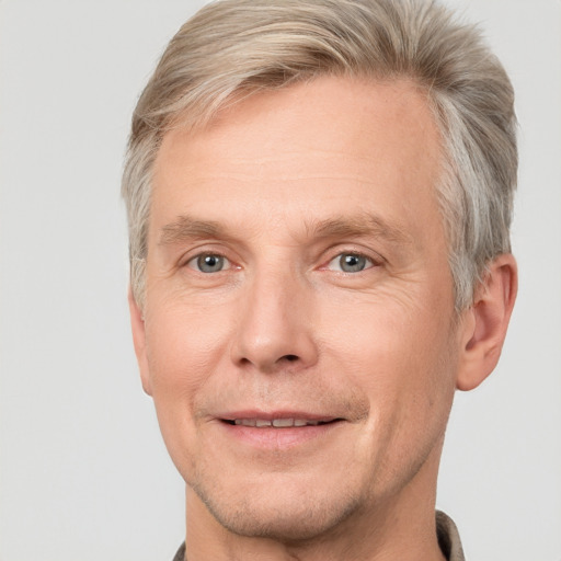 Joyful white adult male with short  brown hair and grey eyes