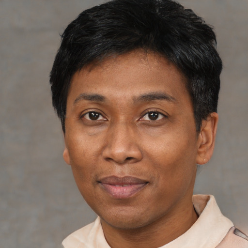 Joyful asian adult male with short  black hair and brown eyes