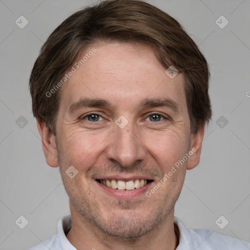 Joyful white adult male with short  brown hair and brown eyes