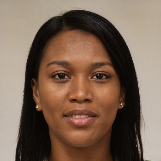 Joyful black young-adult female with long  black hair and brown eyes
