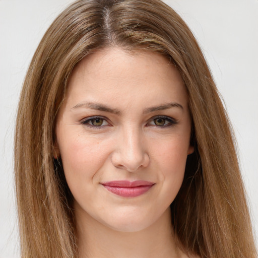 Joyful white young-adult female with long  brown hair and green eyes