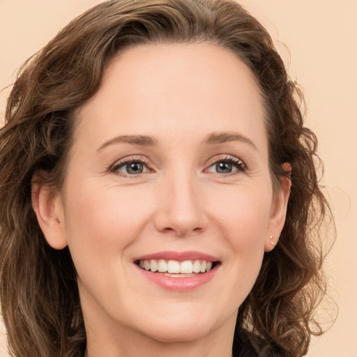 Joyful white young-adult female with medium  brown hair and green eyes