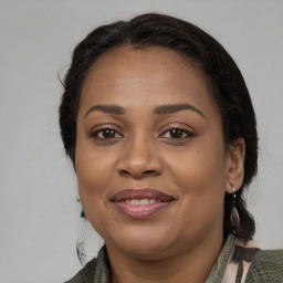 Joyful black young-adult female with medium  brown hair and brown eyes