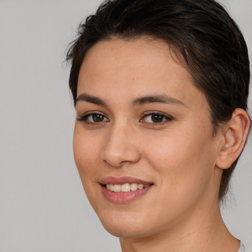 Joyful white young-adult female with medium  brown hair and brown eyes