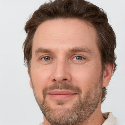 Joyful white adult male with short  brown hair and grey eyes