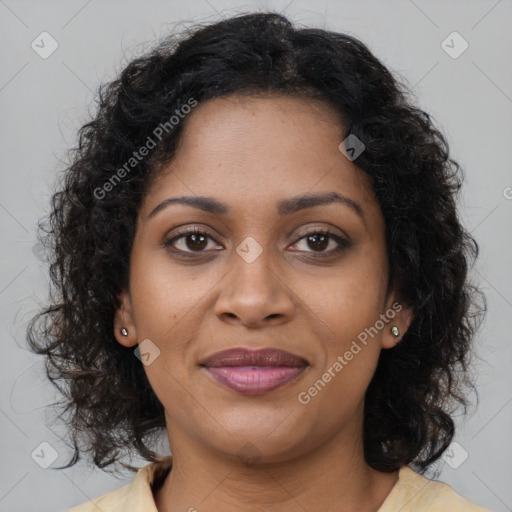 Joyful black young-adult female with long  brown hair and brown eyes