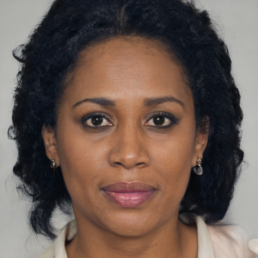 Joyful black young-adult female with medium  brown hair and brown eyes