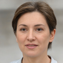 Joyful white adult female with short  brown hair and brown eyes