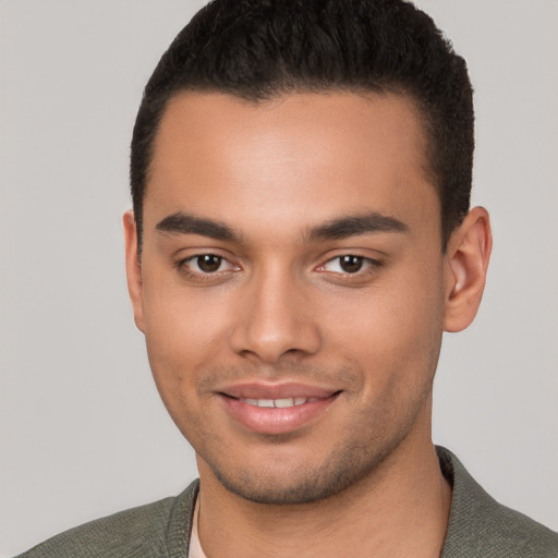 Joyful white young-adult male with short  black hair and brown eyes