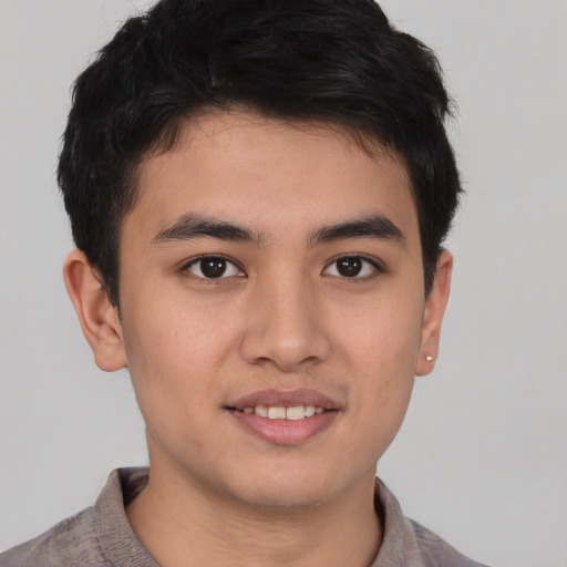 Joyful asian young-adult male with short  brown hair and brown eyes
