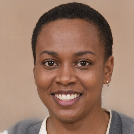 Joyful black young-adult female with short  brown hair and brown eyes