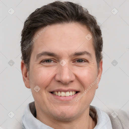 Joyful white adult male with short  brown hair and grey eyes