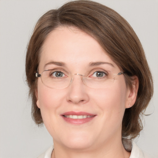 Joyful white adult female with medium  brown hair and grey eyes