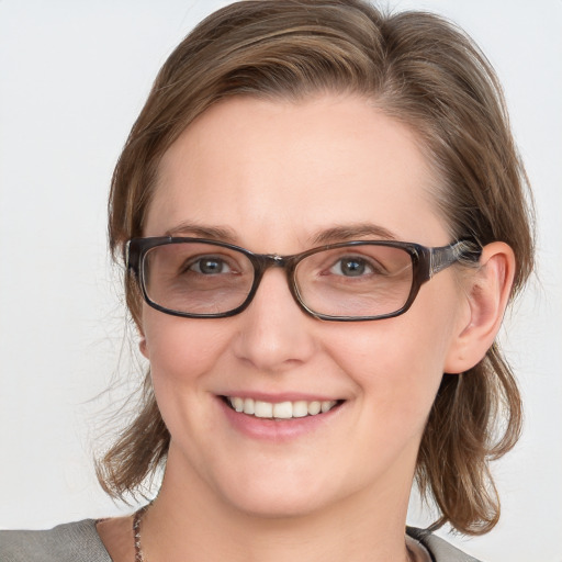 Joyful white young-adult female with medium  brown hair and blue eyes