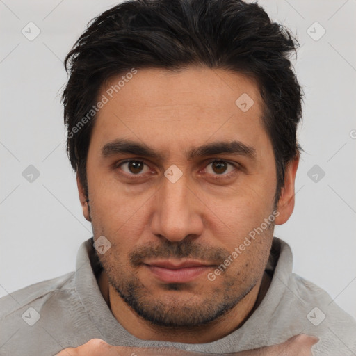 Joyful white adult male with short  black hair and brown eyes