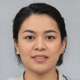 Joyful asian young-adult female with medium  brown hair and brown eyes