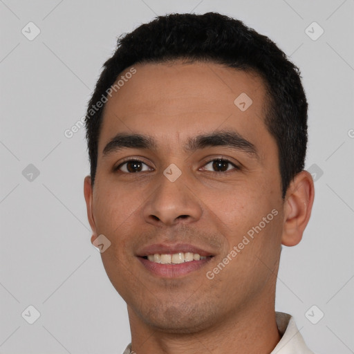 Joyful latino young-adult male with short  black hair and brown eyes