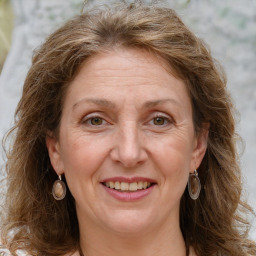 Joyful white adult female with long  brown hair and grey eyes