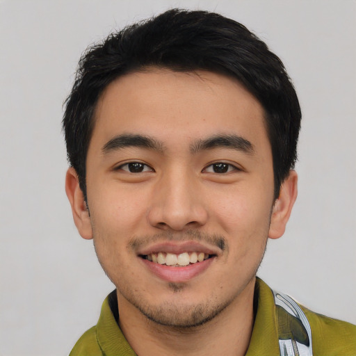 Joyful white young-adult male with short  black hair and brown eyes