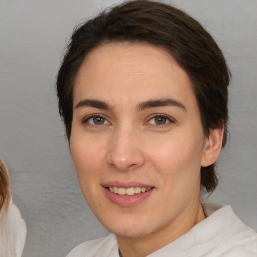 Joyful white young-adult female with medium  brown hair and brown eyes