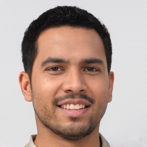 Joyful latino young-adult male with short  black hair and brown eyes