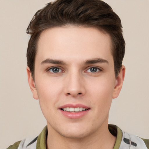 Joyful white young-adult male with short  brown hair and grey eyes