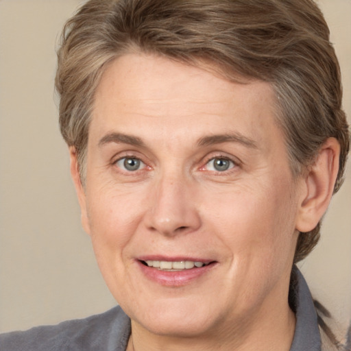 Joyful white adult female with medium  brown hair and grey eyes