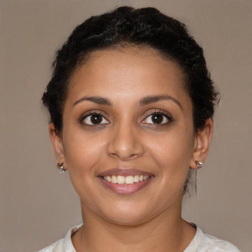 Joyful latino young-adult female with short  brown hair and brown eyes