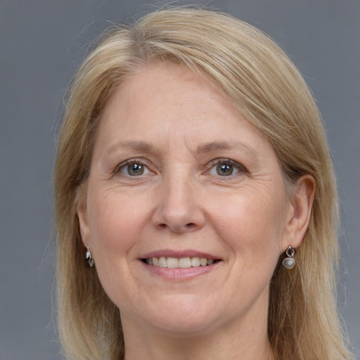 Joyful white adult female with long  blond hair and grey eyes