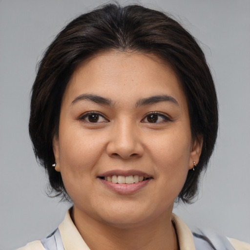 Joyful asian young-adult female with medium  brown hair and brown eyes