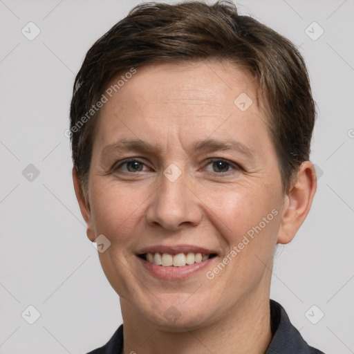 Joyful white adult female with short  brown hair and grey eyes