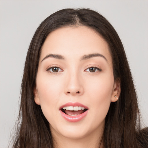 Joyful white young-adult female with long  brown hair and brown eyes