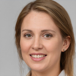 Joyful white young-adult female with medium  brown hair and grey eyes