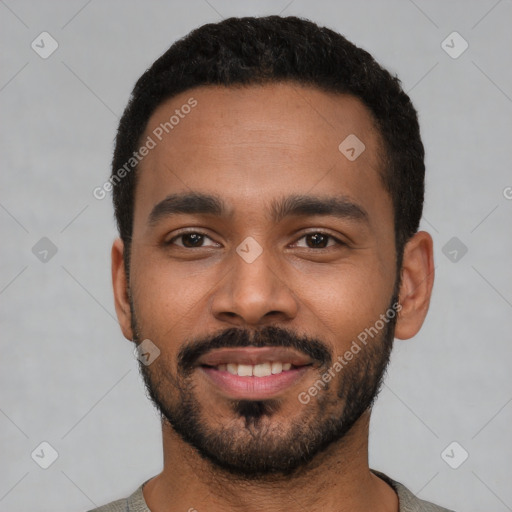 Joyful black young-adult male with short  black hair and brown eyes