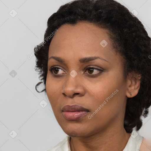 Joyful black young-adult female with short  black hair and brown eyes