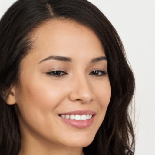 Joyful white young-adult female with long  brown hair and brown eyes