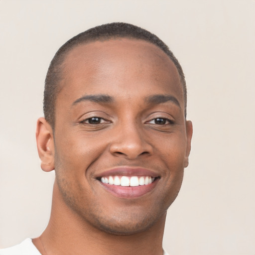 Joyful black young-adult male with short  brown hair and brown eyes