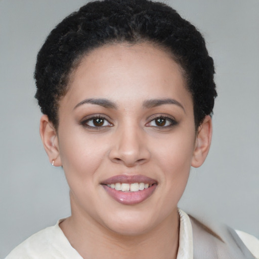 Joyful latino young-adult female with short  brown hair and brown eyes