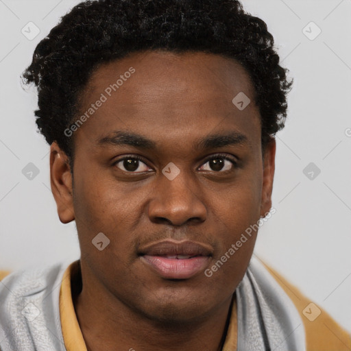 Joyful black young-adult male with short  brown hair and brown eyes
