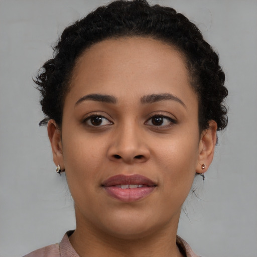 Joyful black young-adult female with short  brown hair and brown eyes