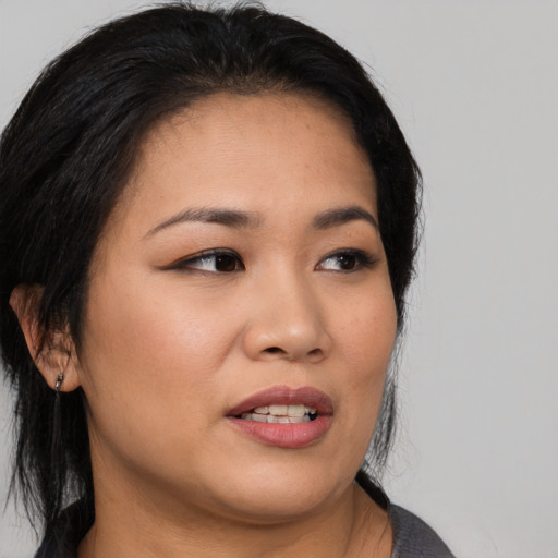 Joyful asian young-adult female with medium  black hair and brown eyes