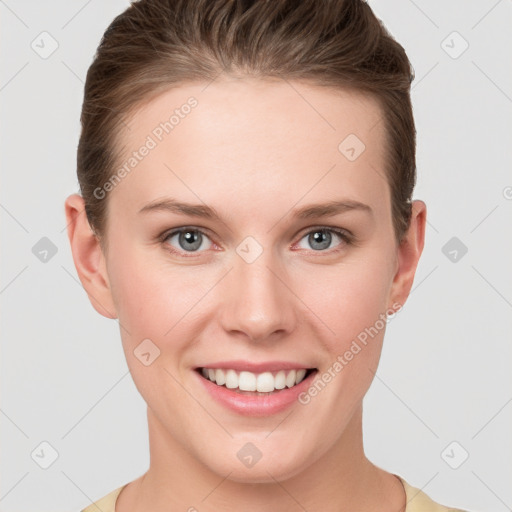 Joyful white young-adult female with short  brown hair and grey eyes