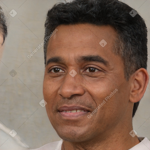 Joyful black adult male with short  black hair and brown eyes