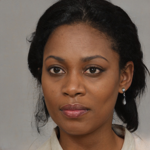 Joyful black young-adult female with medium  black hair and brown eyes