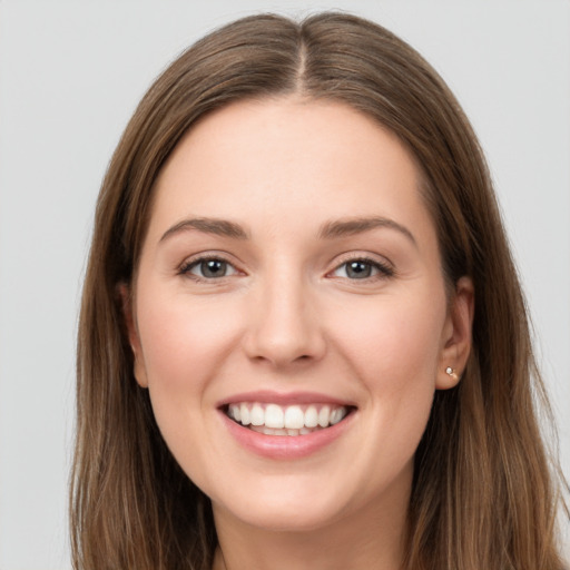 Joyful white young-adult female with long  brown hair and grey eyes