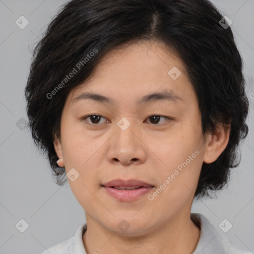 Joyful asian adult female with medium  brown hair and brown eyes