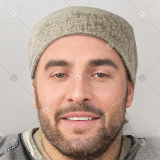 Joyful white young-adult male with short  black hair and brown eyes