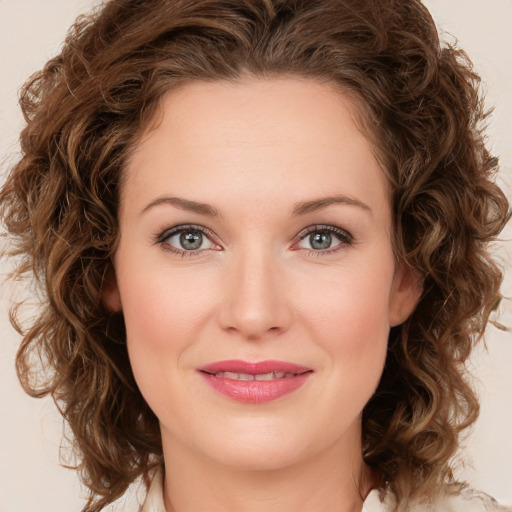 Joyful white young-adult female with medium  brown hair and green eyes